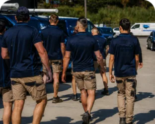 Plumbers walking to their service vans on a Cherrybrook job